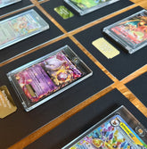 Collection of trading cards on a dark surface with gold accents